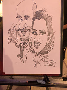 Umelec Janko v akcii počas oslavy životného jubilea, ručná kresba karikatúry k 50. narodeninám.