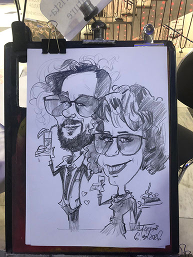 Karikatúra dvoch pánov od umelca Janka nakreslená na firemnej oslave v Poprade ako pamiatka pre hostí.